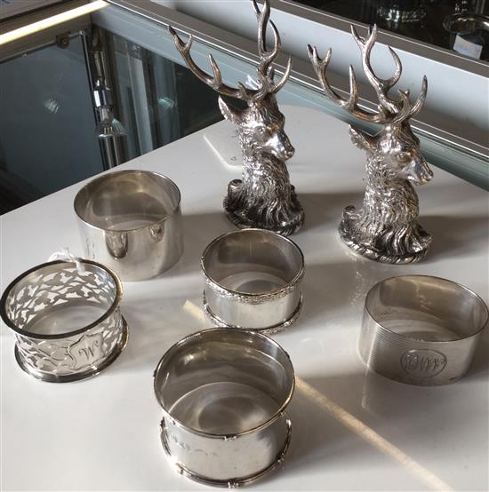 Pair of plated stags head menu holders & five silver napkin rings